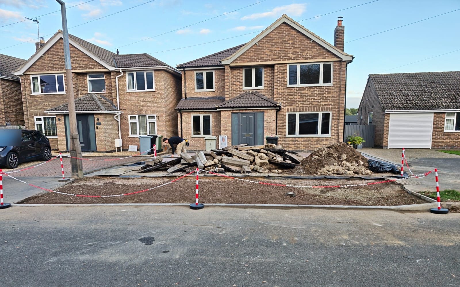 Before: the old slabs and hardstanding broken out and stacked on the frontage Before: the old slabs and hardstanding broken out and stacked on the frontage