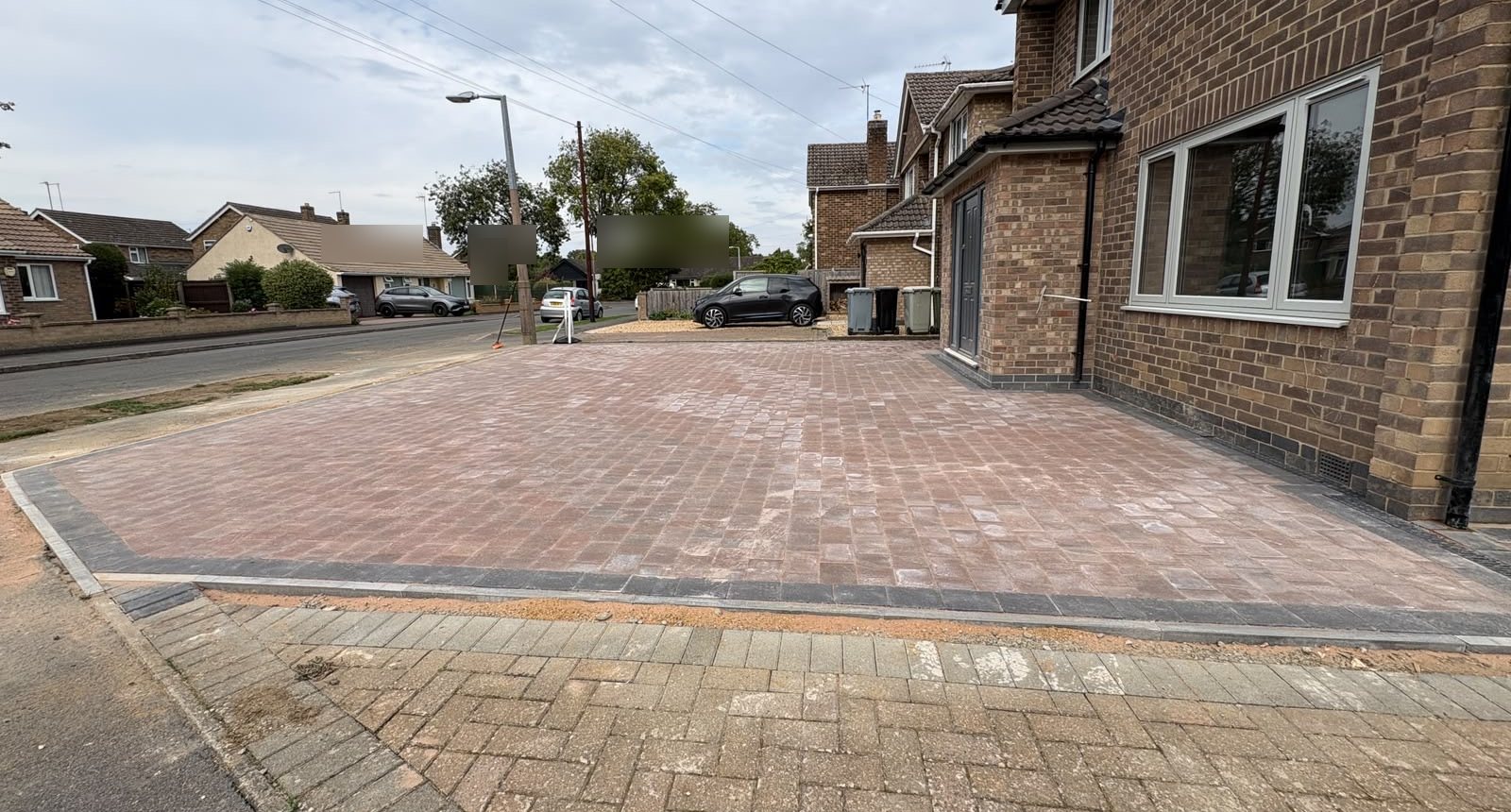 The finished drive from the footway, with the new kerb line along the front The finished drive from the footway, with the new kerb line along the front