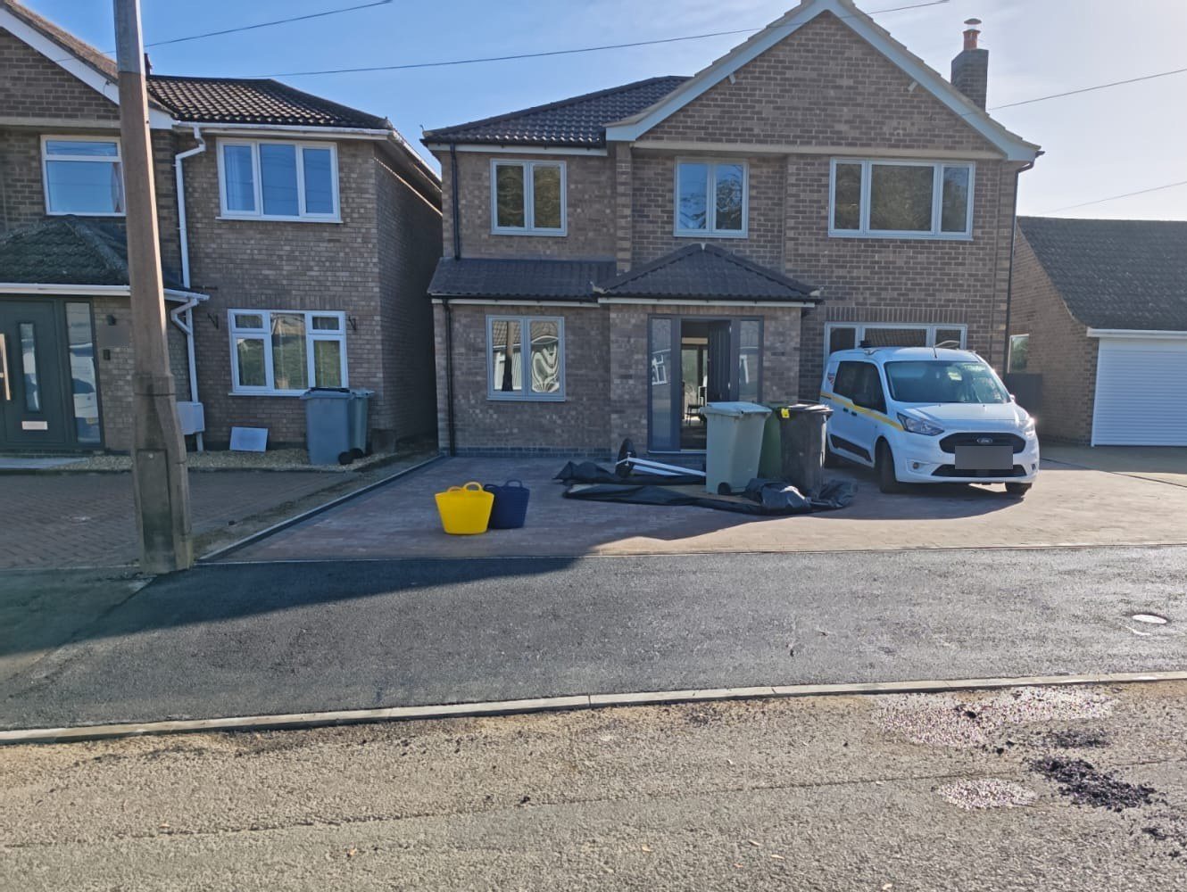 The widened dropped crossing with the footway reinstated in new tarmac The widened dropped crossing with the footway reinstated in new tarmac