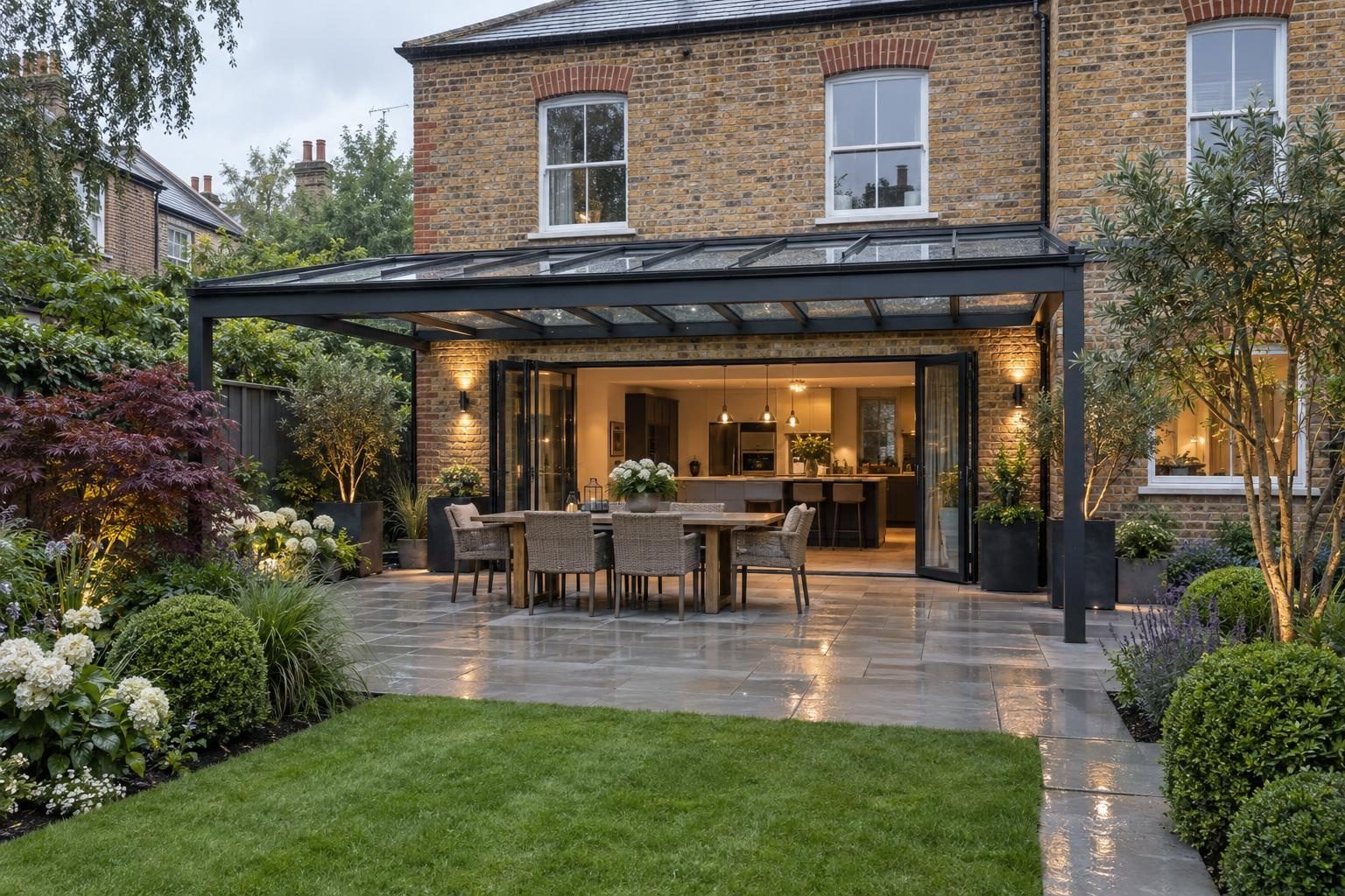 Anthracite aluminium glass veranda over a dining area on a porcelain patio Anthracite aluminium glass veranda over a dining area on a porcelain patio