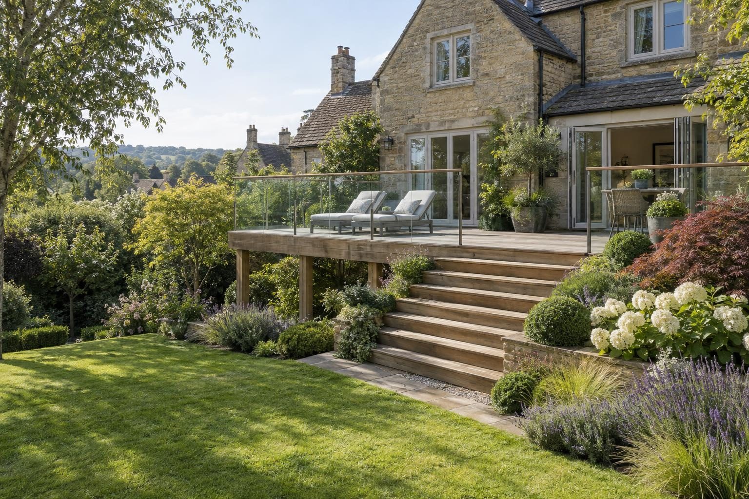Raised timber deck with glass balustrade and wide steps over a sloping garden at a stone house Raised timber deck with glass balustrade and wide steps over a sloping garden at a stone house