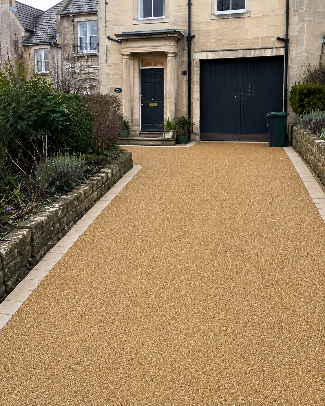 After: a completed golden resin bound driveway at a stone house, replacing old paving