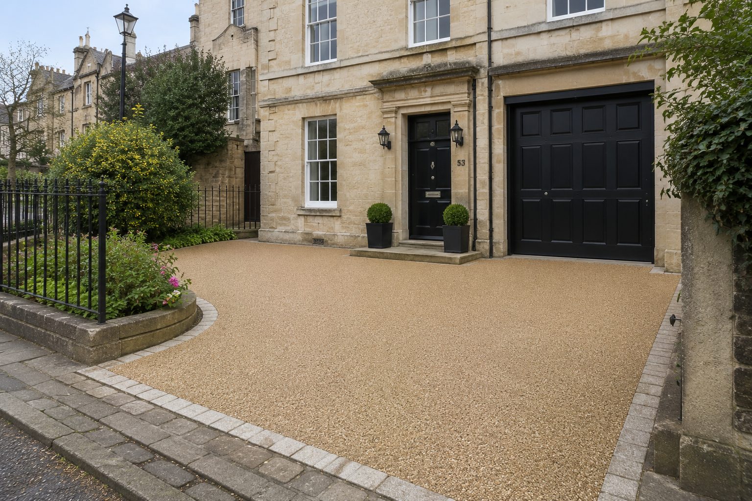 Golden resin bound driveway with block edging at a period stone townhouse