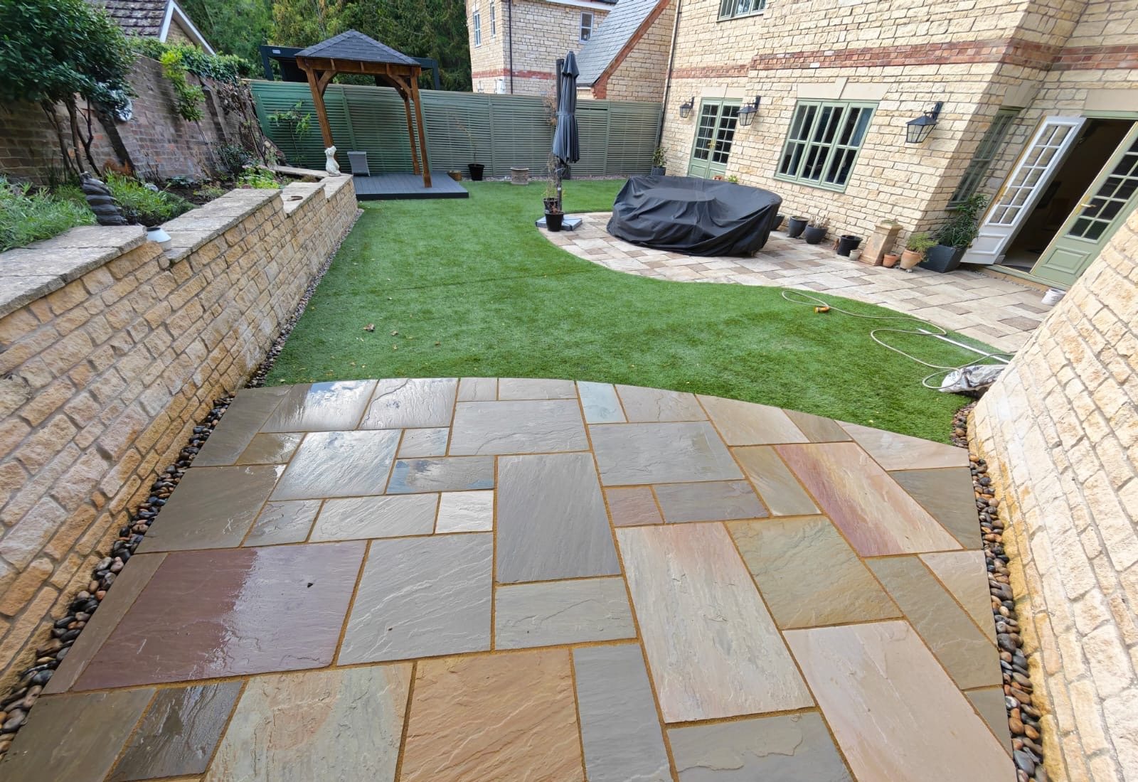 The patio looking back towards the house, with the pebble margin along both walls The patio looking back towards the house, with the pebble margin along both walls